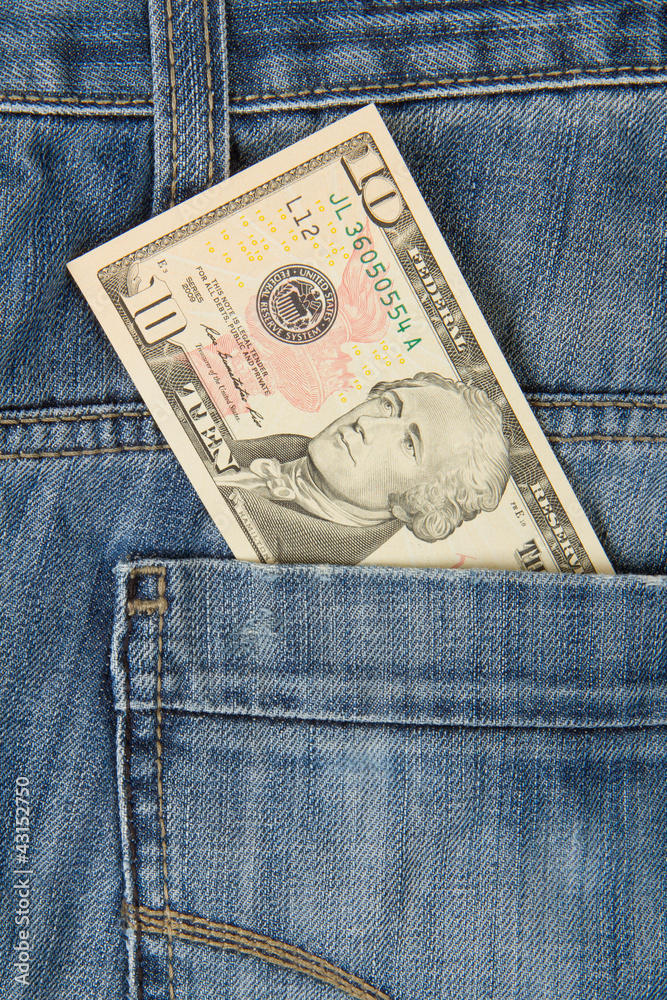 Macro shot of trendy jeans with american 10 dollar bill Macro shot of trendy jeans with american 10 dollar bill