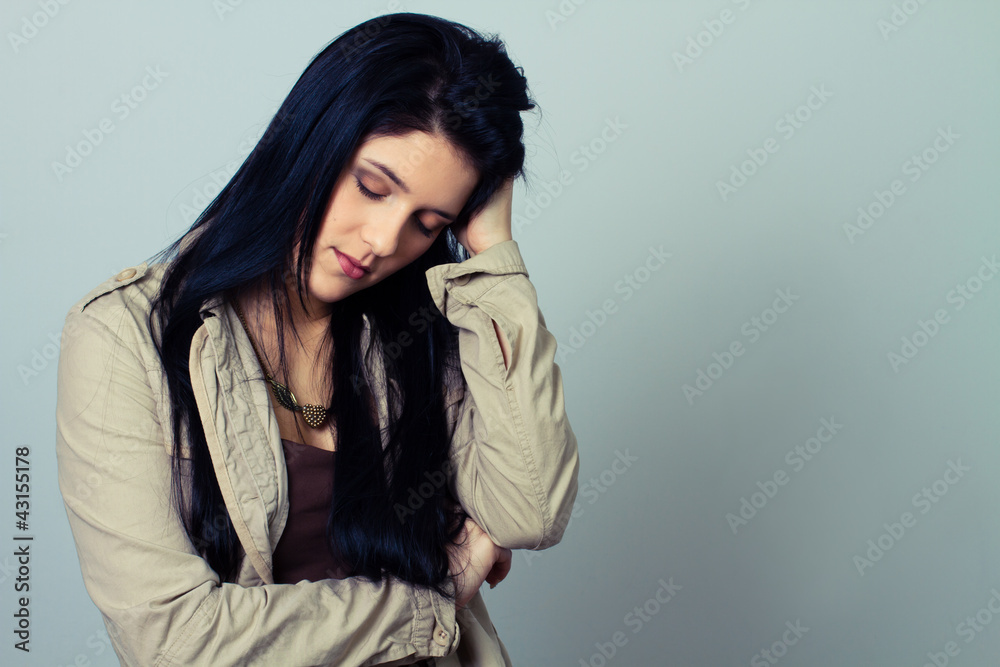 young woman with severe headache, holding hands on head young woman with severe headache, holding hands on head