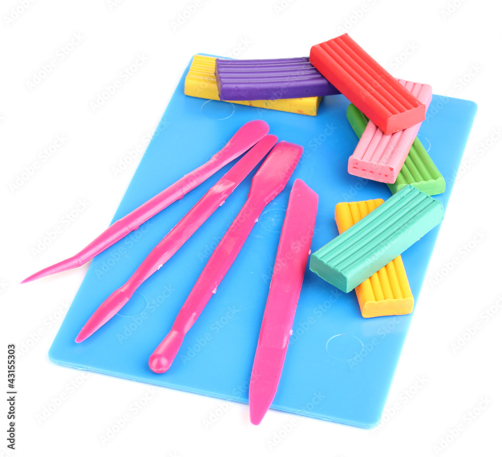 Children bright plasticine on desk with stacks isolated on Children bright plasticine on desk with stacks isolated on
