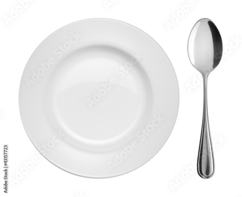 Plate and spoon on white background