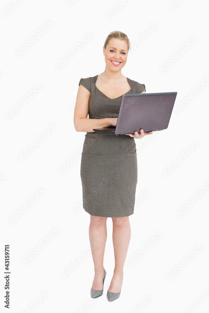 Woman smiling holding a laptop Woman smiling holding a laptop