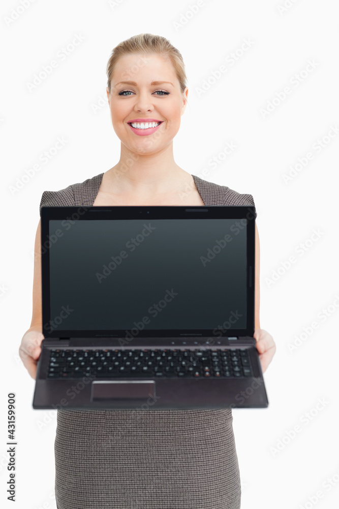 Woman standing while showing a laptop Woman standing while showing a laptop