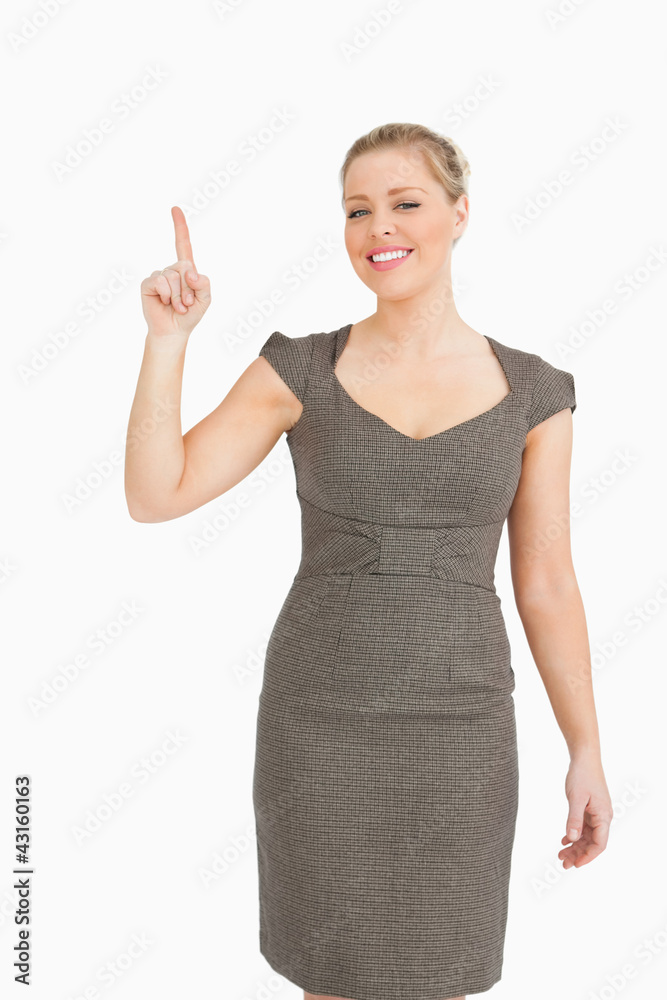 Pretty woman smiling while pointing something up Pretty woman smiling while pointing something up