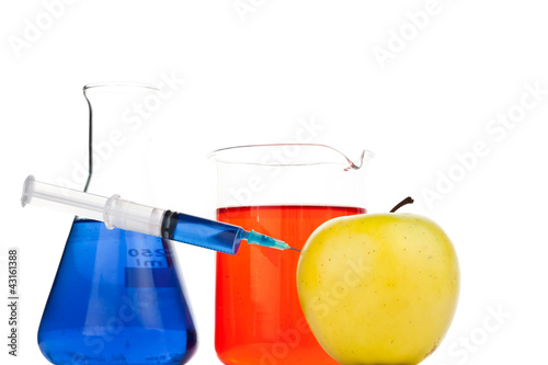 Syringe pricking an apple