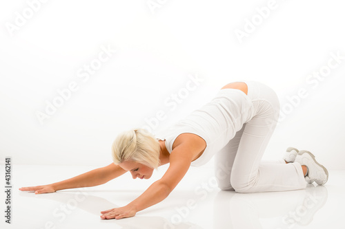 White fitness woman stretch body at Pilates.