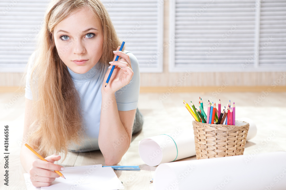 teenage girl lying on floor drawing teenage girl lying on floor drawing