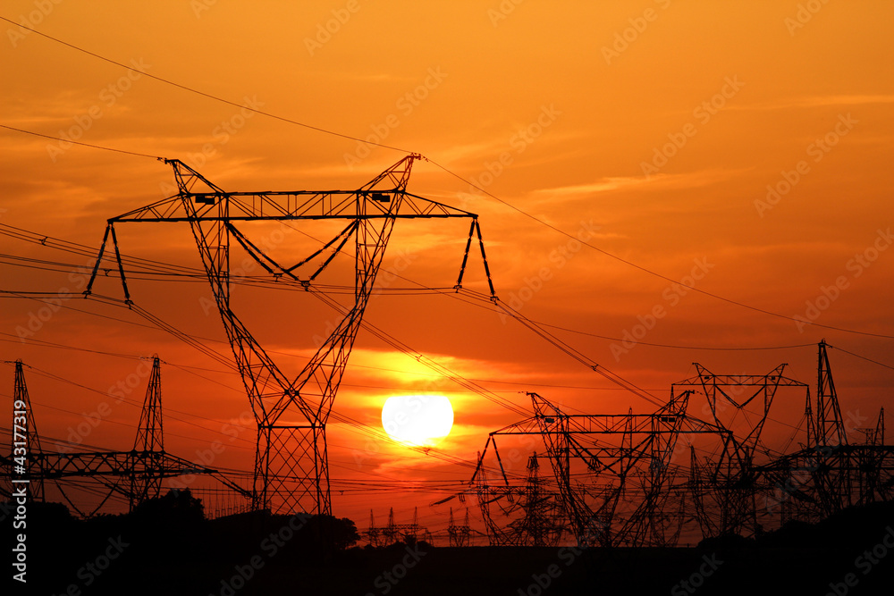 high voltage electric pole during sunset