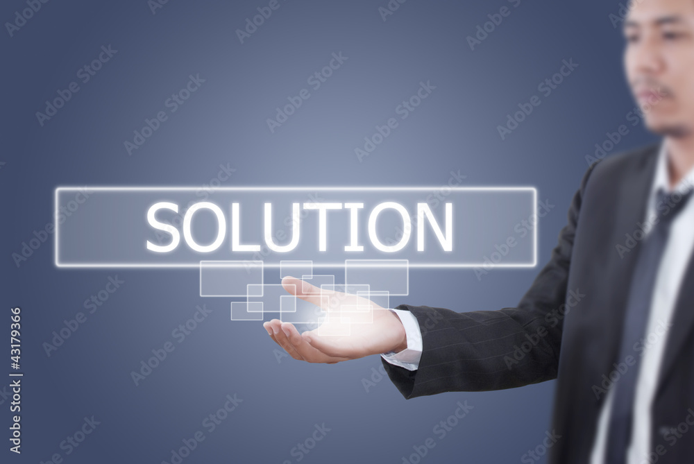 Businessman holding Solution word on the whiteboard.