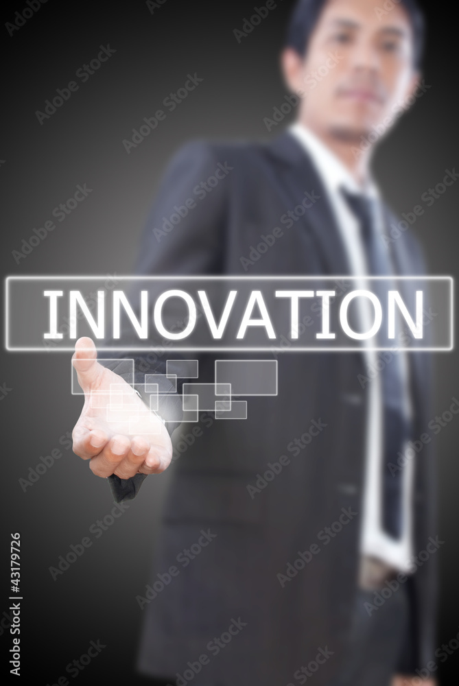 Businessman holding Innovation word on the whiteboard.