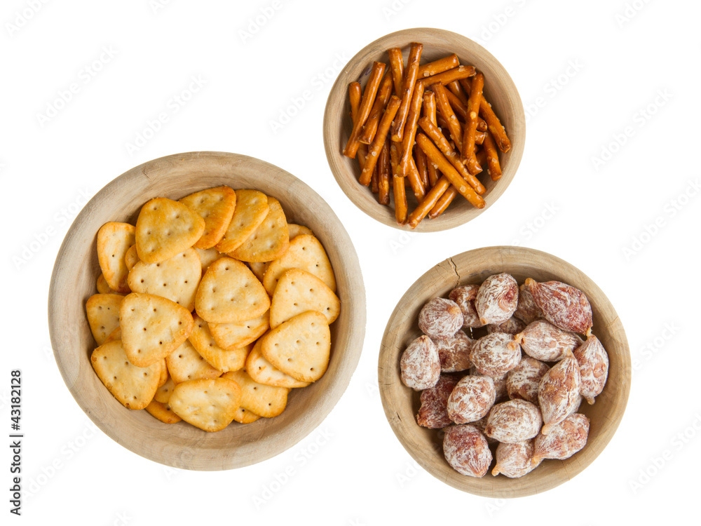 Italian salami and typical dutch salty snacks in wooden bowl Italian salami and typical dutch salty snacks in wooden bowl