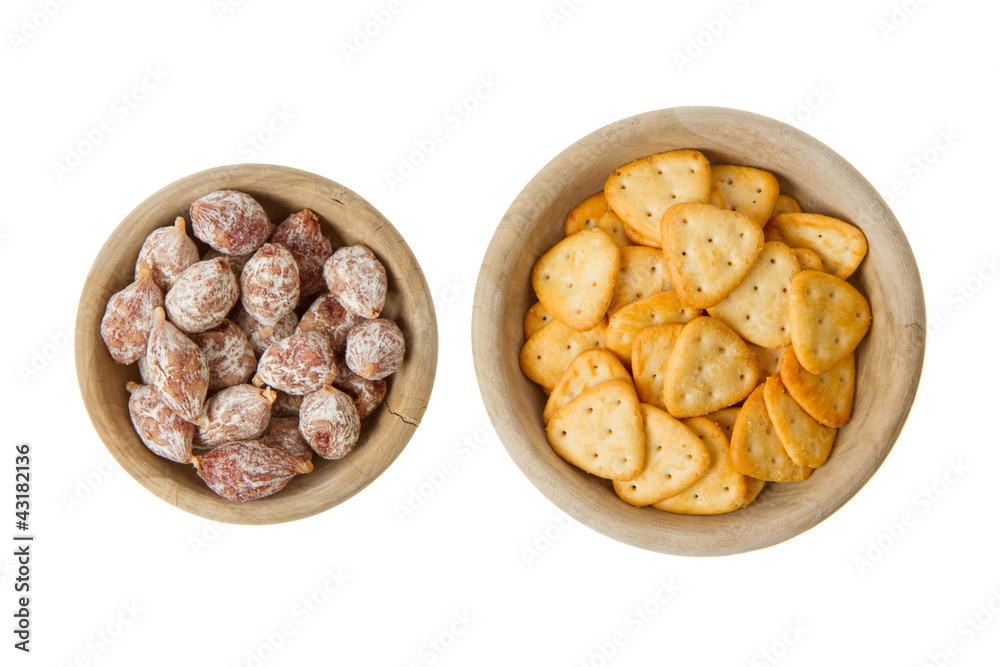 Italian salami and typical dutch salty snacks in wooden bowl Italian salami and typical dutch salty snacks in wooden bowl
