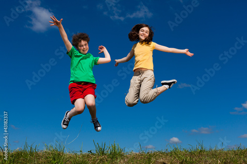 Girl and boy running, jumping outdoor