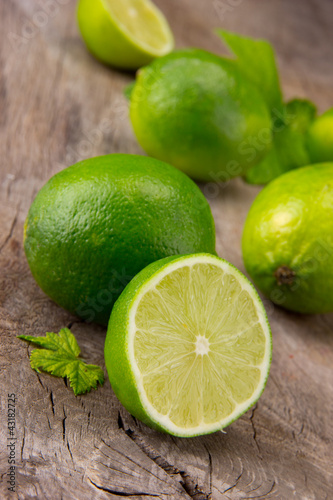 Fresh limes on wooden table
