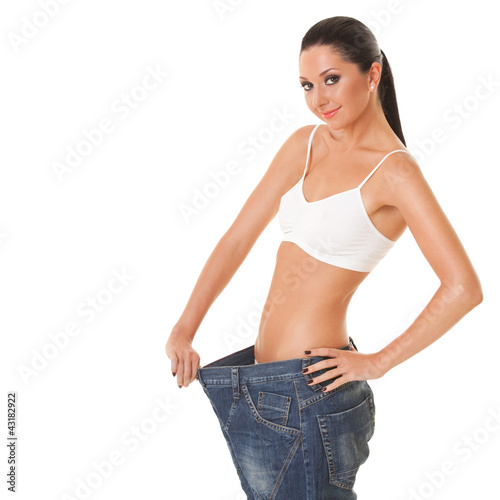Pretty woman shows her weight loss by wearing an old jeans © Dmytro Sunagatov