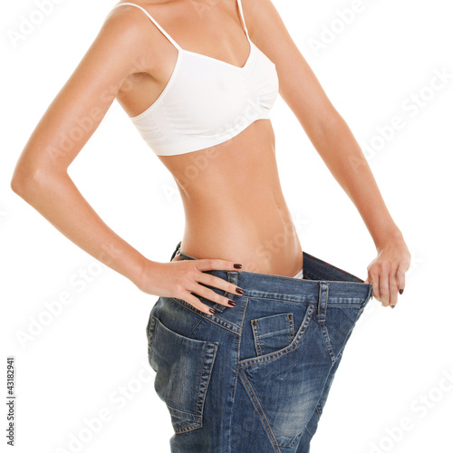 Funny woman shows her weight loss by wearing an old jeans, isola