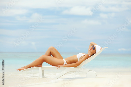 Happy fashion woman rest on the beach