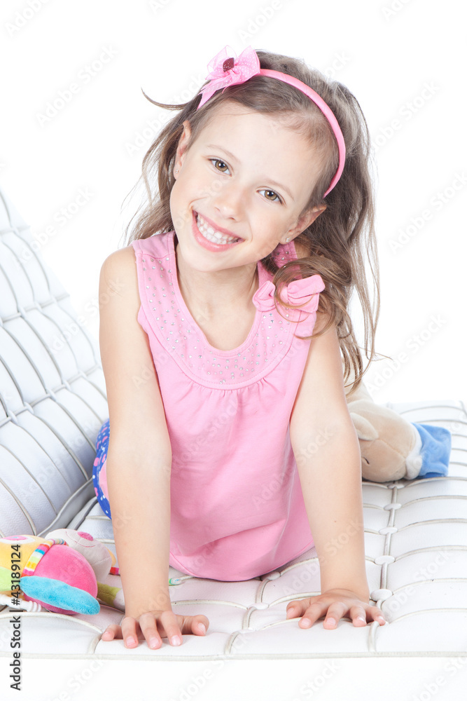 Beautiful little girl lying on a sofa Stock Photo | Adobe Stock