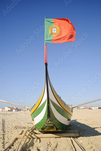 Typical portuguese fishing boat on the beach, Espinho, Portugal © dinozzaver