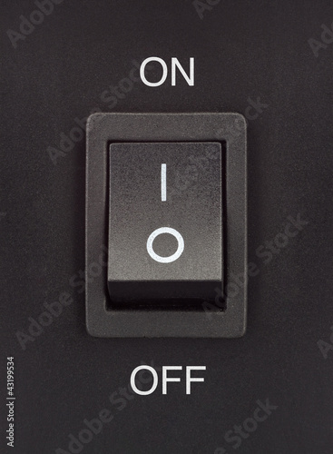 Black toggle switch on black surface - On Off
