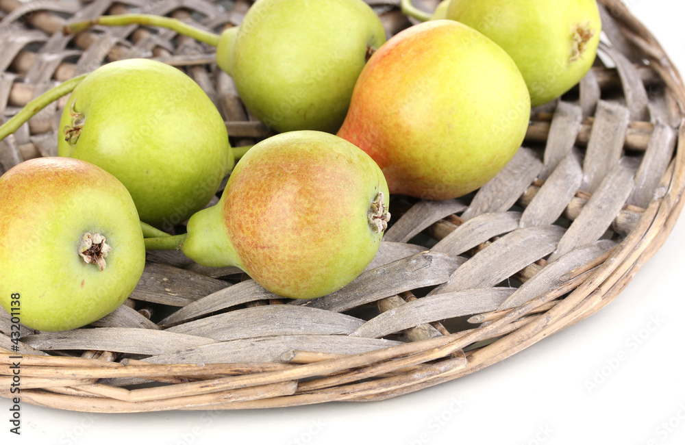ripe pears on wicker mat isolated on white. ripe pears on wicker mat isolated on white.