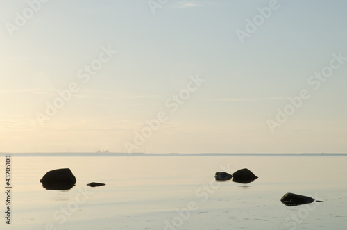 Black rocks in calm water
