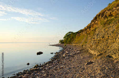 Calm and bright coastline with cliff steep