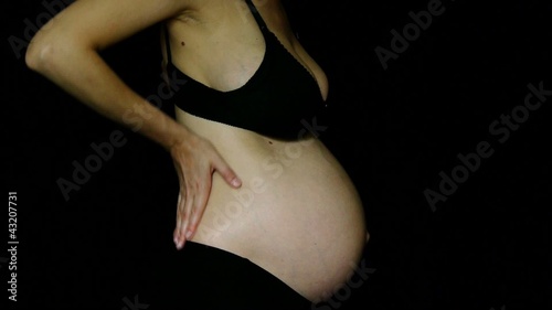 Pregnant female having a back pain photo
