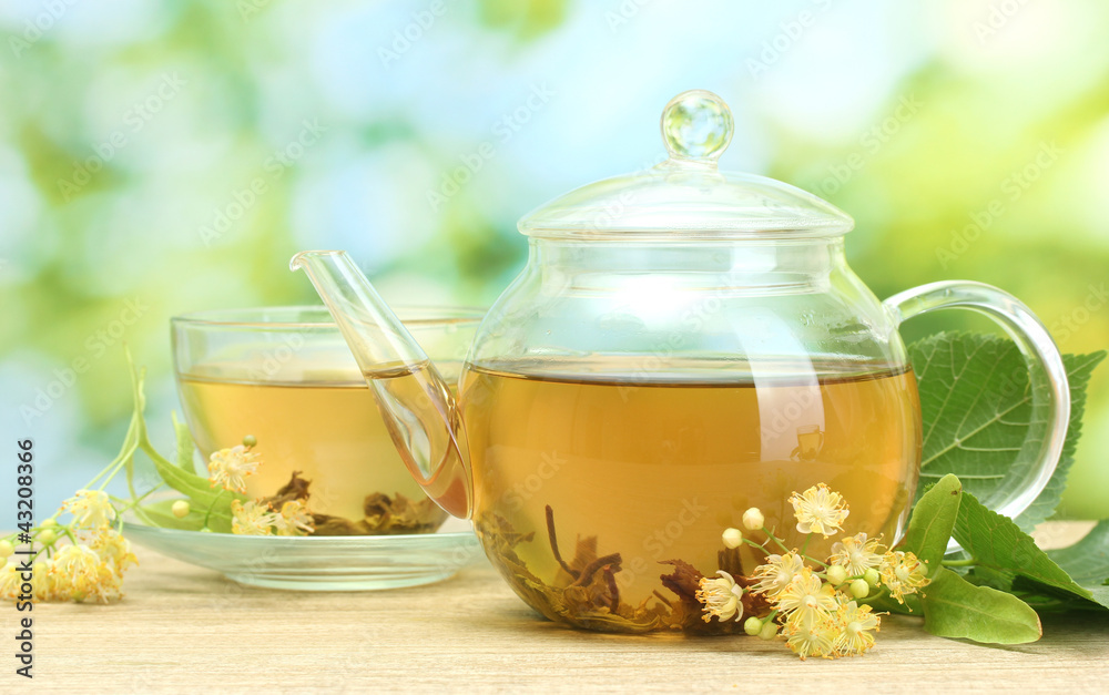 teapot and cup with linden tea and flowers teapot and cup with linden tea and flowers
