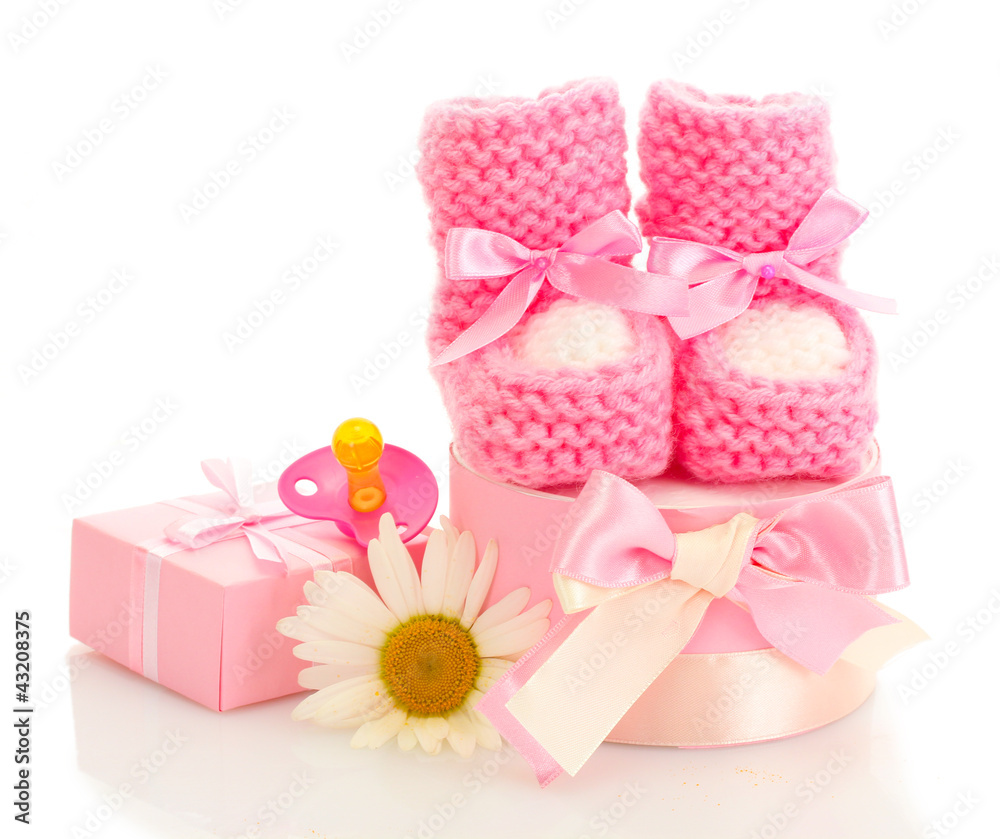 pink baby boots, pacifier, gifts and flower isolated on white pink baby boots, pacifier, gifts and flower isolated on white