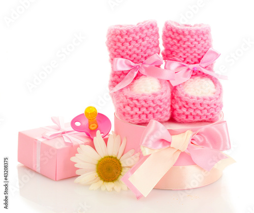 pink baby boots  pacifier  gifts and flower isolated on white
