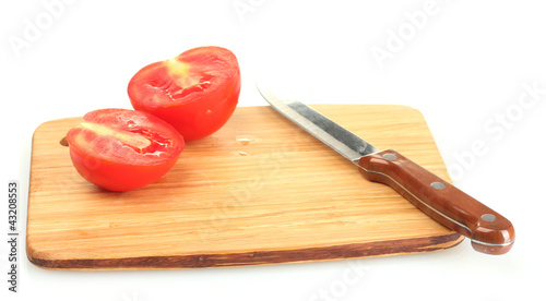 Ripe red tomatoes and knife on cutting board isolated on white