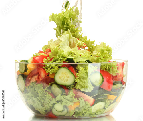 fresh vegetable salad in transparent bowl with spoon and fork