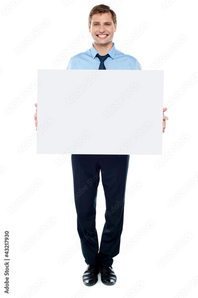 Businessman holding blank white billboard Businessman holding blank white billboard