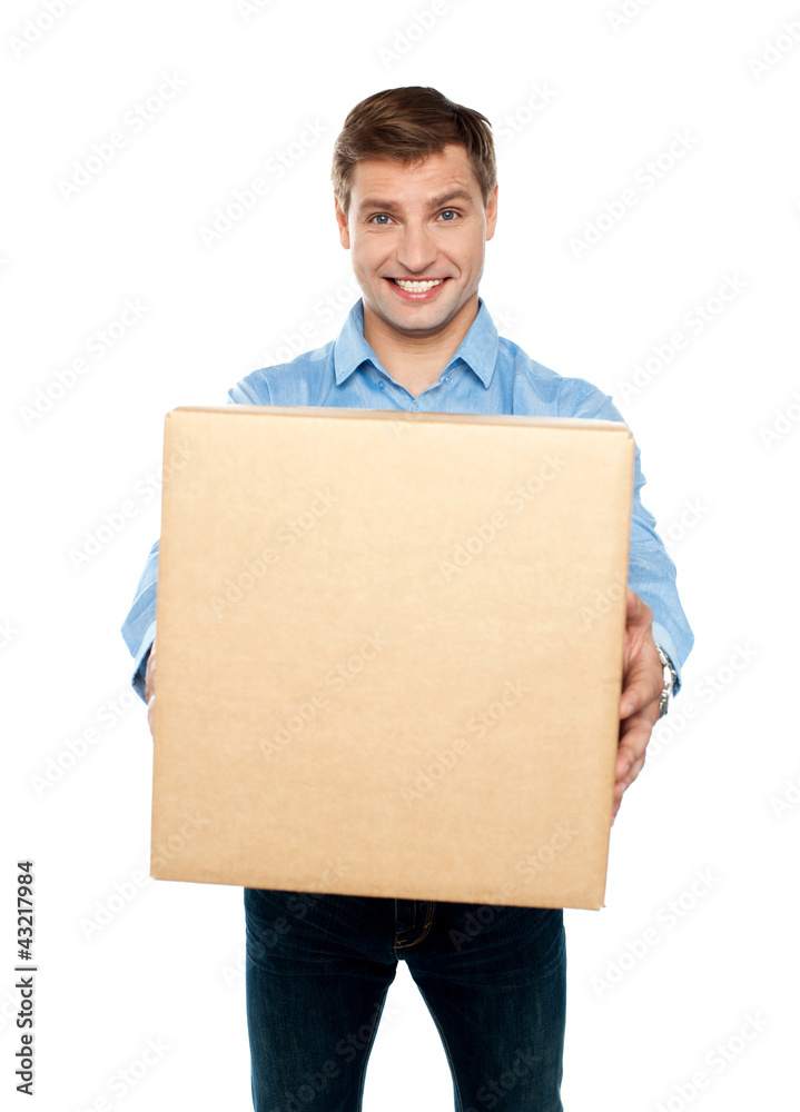 Charming handsome male holding carton Charming handsome male holding carton