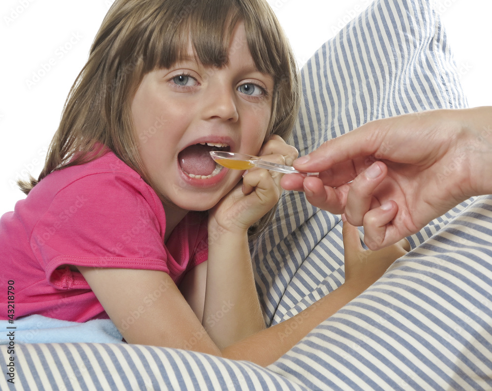 little girl taking cough syrup fom her mother little girl taking cough syrup fom her mother