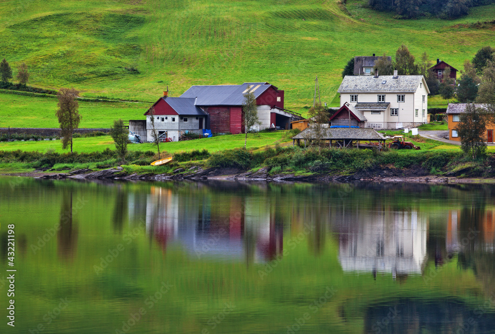 Buildings on fjord shore