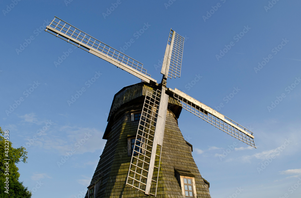 Retro wooden mill  wings against blue sky