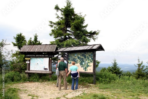tourists looking at map on top of Jaworzyna near Krynica