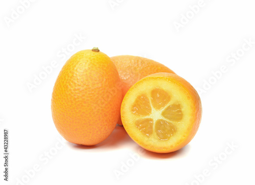 Group of sliced and whole kumquats on white background