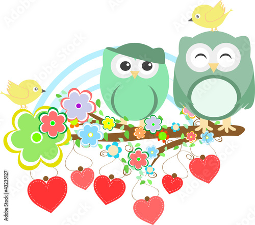 Two cute owls and bird on the flower tree branch