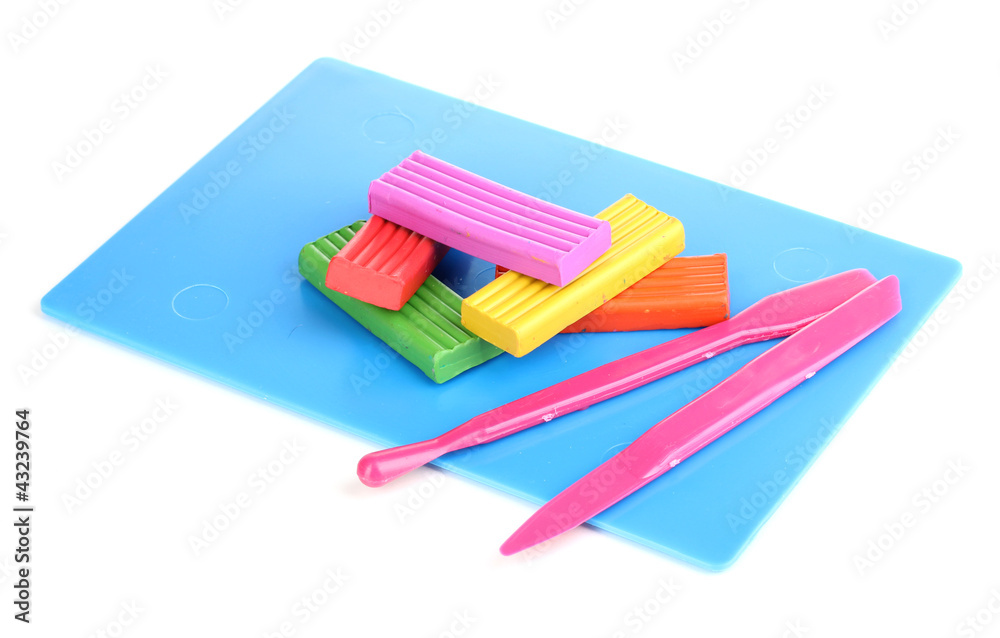Children bright plasticine on desk with stacks isolated on Children bright plasticine on desk with stacks isolated on