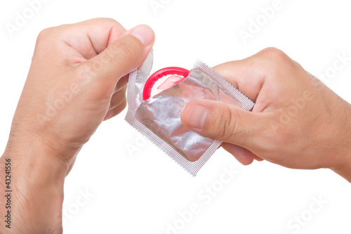 man is opening a condom, isolated on white
