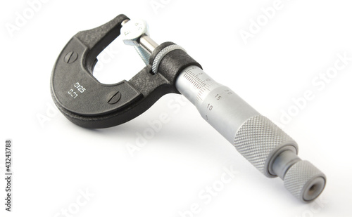 Micrometer and bolt on white background