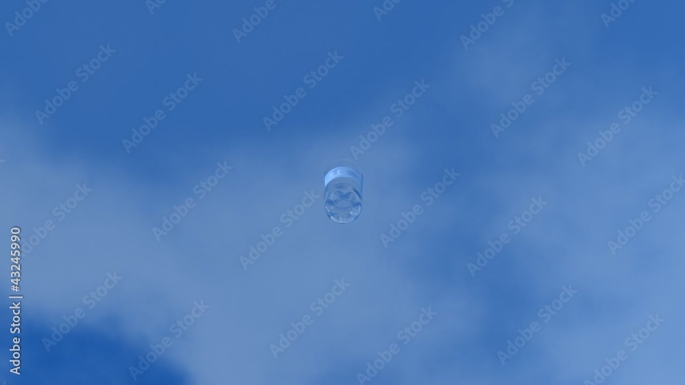 Plain glass of water falling from a blue sky . Plain glass of water falling from a blue sky .