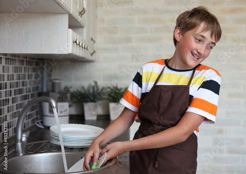 boy doing the dishes