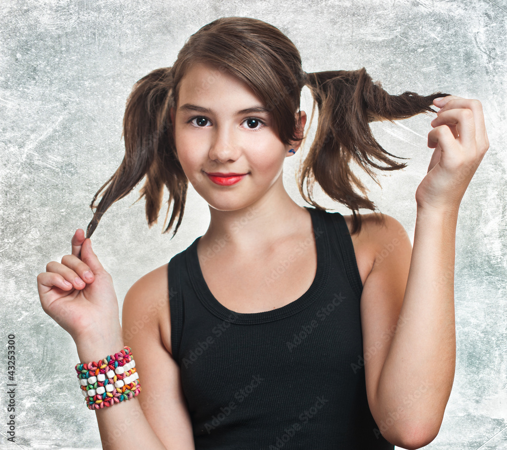 A beautiful teen girl in black top holding her pigtails Stock Photo ...