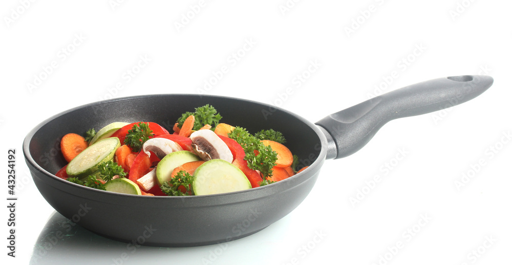 frying pan with vegetables on white frying pan with vegetables on white