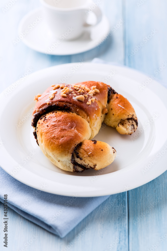 Sweet poppy seed croissant on a plate