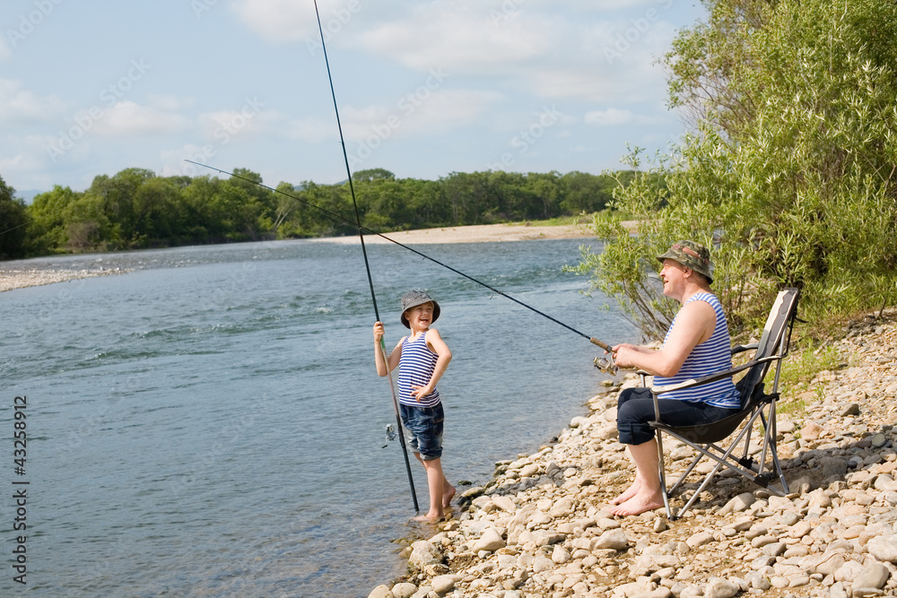 Grandfather and grandson fishing Grandfather and grandson fishing