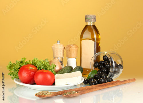 Ingredients for a Greek salad on brown background close-up